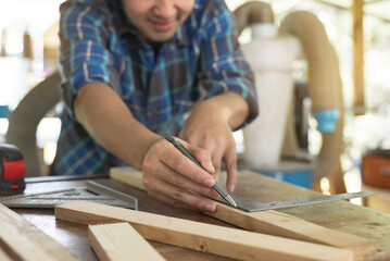 Hands of person doing diy project at home. Man measuring wood to doing cabinet craftworks as a hobby.