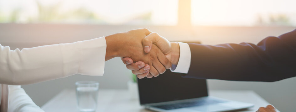 two business people shaking hands after contract is done.