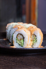 Sushi Maki, Breaded prawn, avocado, flambéed fan shells, parmesan cheese and butter.