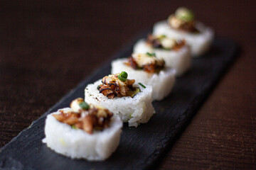 Sushi Maki, Breaded prawn, avocado, flambéed fan shells, parmesan cheese and butter.