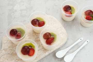 Fruity Milk Pudding, sweet vanilla silk pudding dessert with strawberry, grape and kiwi fruit topping
