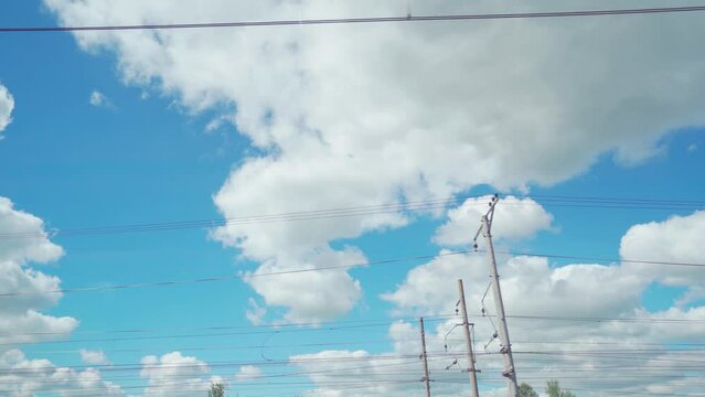 4k, view of the sky with clouds from the window of a moving train
