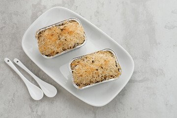 Baked Macaroni Schotel in an aluminium foil cup.