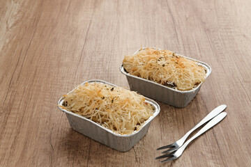 Baked Macaroni Schotel in an aluminium foil cup.