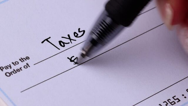 Close-up shot of a check being writen.