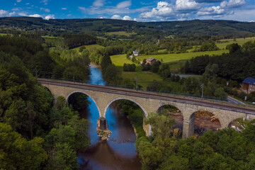 Fototapeta na wymiar Railroad bridge over the Ambleve river, in Roanne-Coo, Belgium