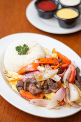 lomo saltado, with vegetables, served with rice
