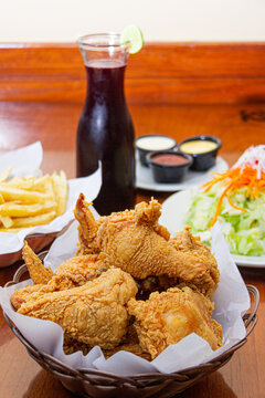 Broaster chicken, served with potatoes and salad
