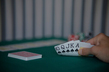the poker game in casino chips cards and the poker table, winning combination in poker, flush royal