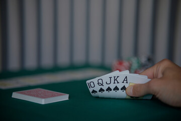 the poker game in casino chips cards and the poker table, winning combination in poker, flush royal