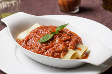 Delicious meat filled pasta on a plate. Italian cannelloni, Spanish cannelloni. - Image