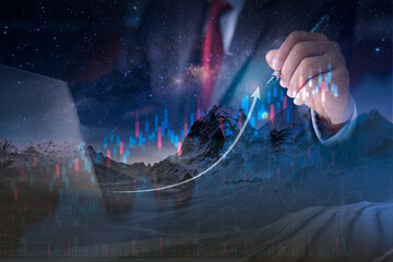Double exposure of businessman hand holding with pen and  modern computer,Concept for business strategy, Increase graph 
 climbing mountain as Success business concept,Growth economic
