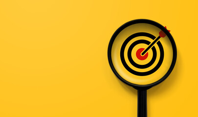 Magnifying glass with aiming dart board icon with copy space on yellow background