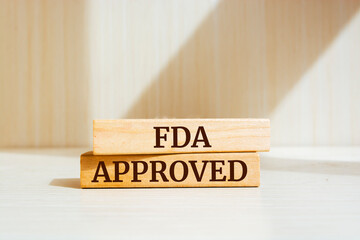 Wooden blocks with words 'FDA approved'. Business concept