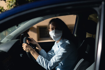 Caucasian woman sitting in a car wearing coronavirus covid19 mask
