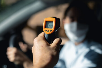 Caucasian woman sitting in a car wearing coronavirus covid19 mask
