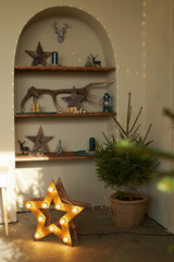 Green live Christmas trees spruce in wicker baskets, gift boxes in interior on concrete floor. Scandinavian Pinterest style