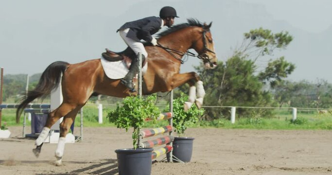 African American man jumping an obstacle with his Dressage horse