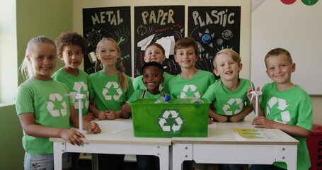 Group of kids wearing recycle symbol t shirt in the class - Powered by Adobe