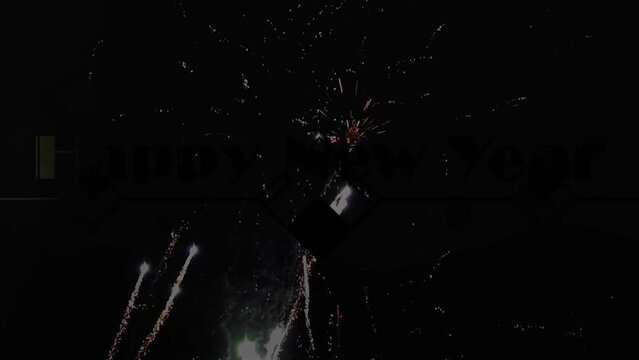 Animation of glowing gold happy new year text with fireworks over black background