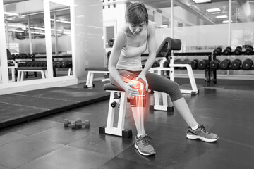 Injured woman holding knee 