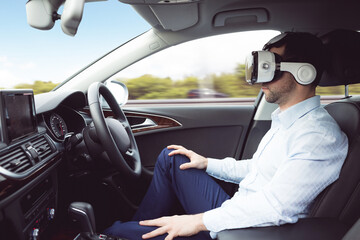 man behind the wheel wearing a virtual reality helmet