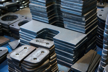 Group of workpieces cut of metal sheet in storehouse