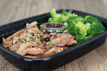 Take out order of teriyaki chicken with rice and broccoli is conveniently packed in a microwavable...