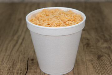 Mexican rice packed in a to go container as a side order for the dinner meal