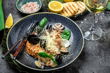 Italian risotto with shrimps, octopus, clams, tomatoes and mussels in shells. Mediterranean...