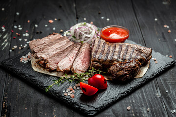 Beef steak. Grilled meat. Dry Aged Barbecue Ribeye Steak on wooden background. banner, menu, recipe...