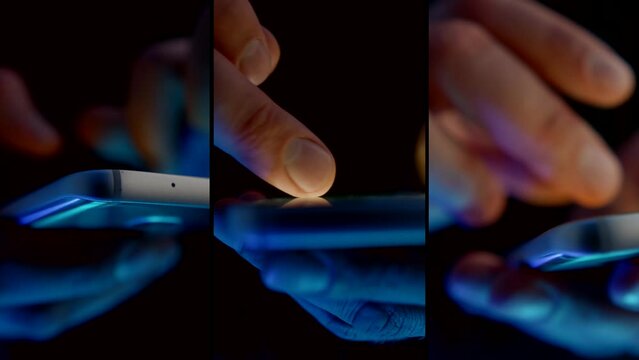 person is using smartphone in night, closeup view of fingers on touch screen, anonymous user