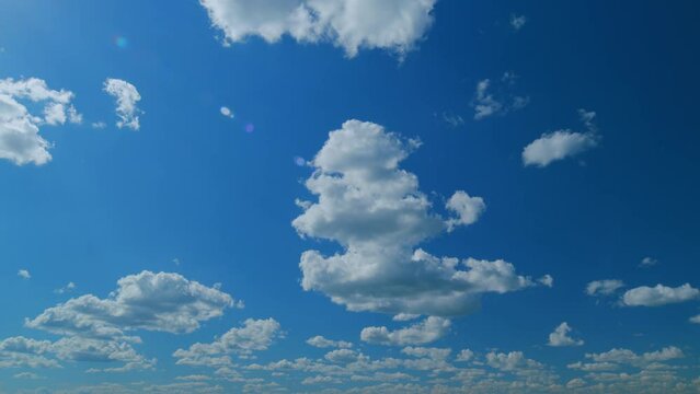 Soft white clouds. Clouds form against a dark blue sky. Blue sky white clouds. Time lapse.