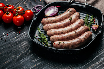 raw sausages with spices and rosemary on cutting board. Cooking ingredients. Natural healthy food concept. top view