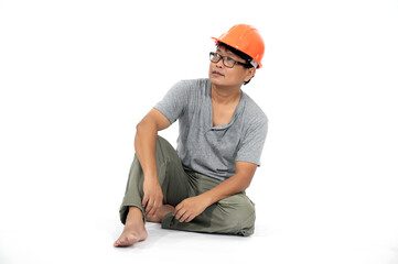 A middle-aged Korean engineer in a private suit and orange hat sits and relaxes.Full length studio shot isolated on white. 