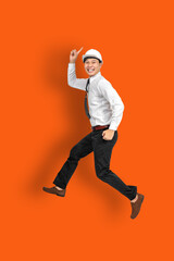 Full length photo of attractive crazy young business man or engineering man jump high supporting...