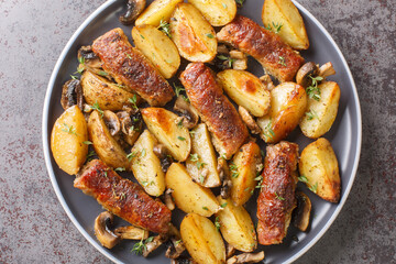 Comfort food meat rolls with mushrooms and potatoes close-up in a plate on the table. horizontal top view from above