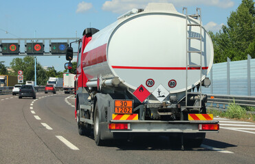 tanker truck in the busy street for transporting flammable material - obrazy, fototapety, plakaty