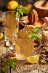 Ginger tea with ingredients on an old wooden table.