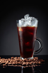 Ice coffee in frozen glass and coffee beans.