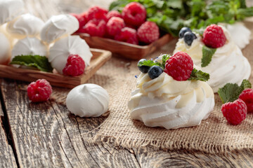 Dessert Pavlova with raspberries, blueberries and mint.