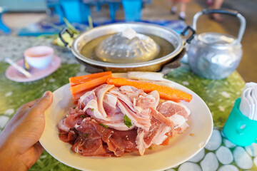 Thai barbecue Grill Pork on hot pan buffet, Moo-gata Pork pan It's traditional Thai style BBQ Fresh Pork, Sliced Pork ,Moo Kra Ta Thai buffet with pork, chicken and other meats, cooked on brass barbec