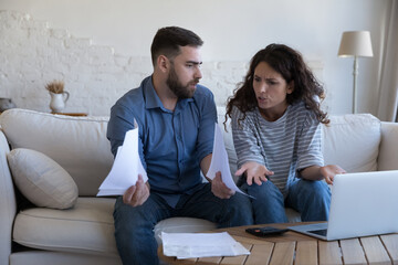 Couple pay bills on laptop, count expenses, making budget analysis, manage family finances, review...