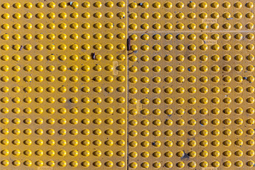 yellow anti slip Mat iwith knobs at floor f