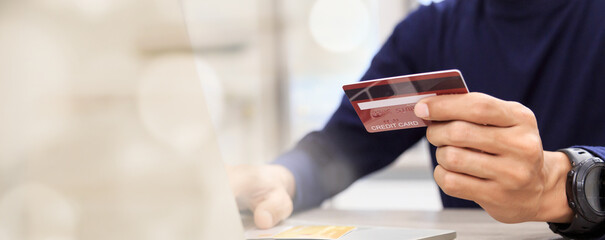 Businessman holding credit card for online shopping bill on smartphone, positive man shopping online remote payment , smart payment concept individual bank