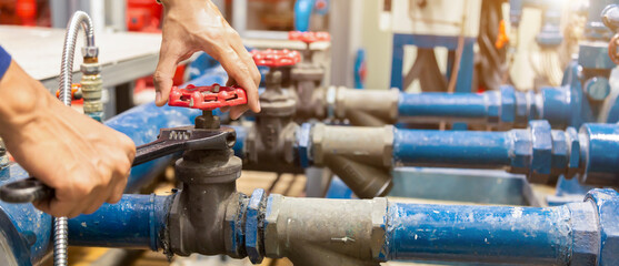 Plumber repairing and performing maintenance big water pipes.