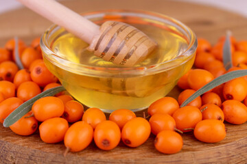 Ripe sea buckthorn berries with honey. Close-up. Healthy food.
