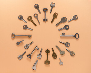 Key frame. Background from different old keys. view from above. Door key in white and yellow metal.