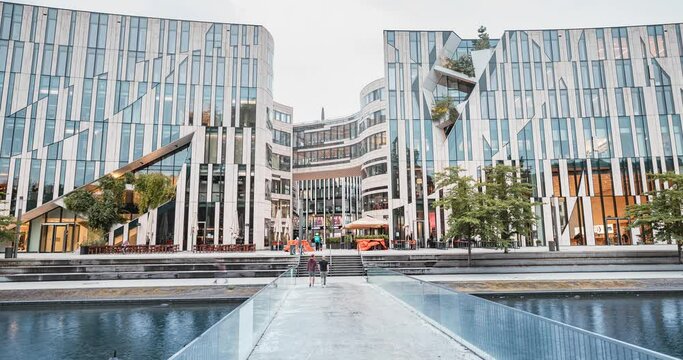 Timelapse with Ko Bogen famous architecture building and water channel with bridge in Dusseldorf. It is popular sightseeing, business and shopping center.