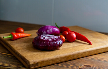 red and white onions on a wooden cutting board
